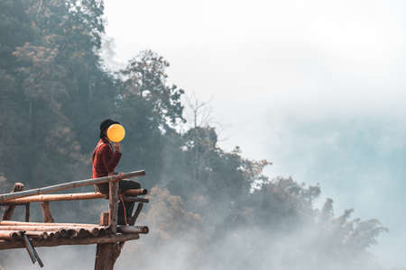 young happy woman with balloons at sunset in summerの写真素材