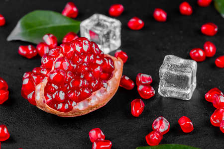 Ripe pomegranate fruits on the wooden backgroundの写真素材