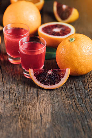 Sliced Sicilian Blood oranges fruits over old dark wooden background. Top view.の写真素材
