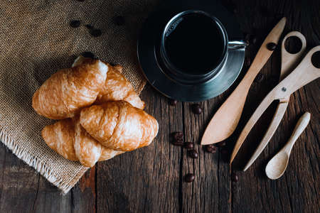 Coffee and croissants on the wooden background, top viewの写真素材