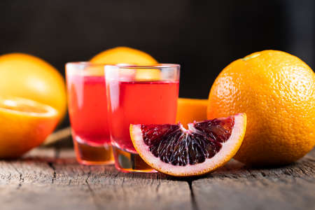 Sliced Sicilian Blood oranges fruits over old dark wooden background. Top view.の写真素材