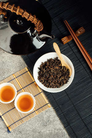 Hot tea in glass teapot and cup with steamの写真素材