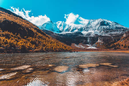 Pearl Lake or Zhuoma La Lake and snow mountain in autumn in Yading Nature reserve, Sichuan, China.の写真素材