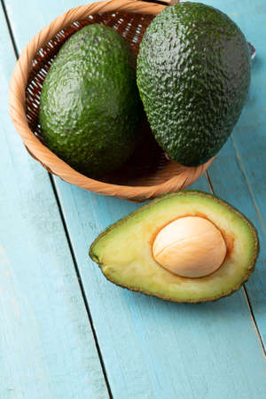 Avocado on old wooden table.の写真素材