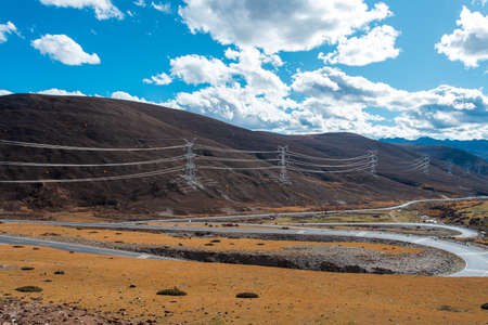 Colorful landscape with beautiful mountain road with a perfect asphalt. High rocks, blue sky at sunrise in summerの写真素材