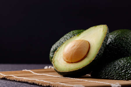 Avocado on old wooden table.