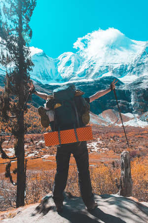 Silhouette of man hold up hand on the peak of mountain,success conceptの写真素材