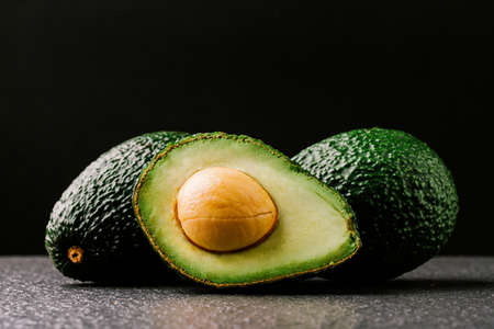 Avocado on old wooden table.の写真素材