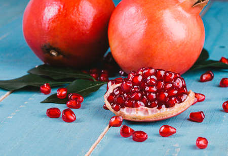Ripe pomegranate fruits on the wooden backgroundの写真素材