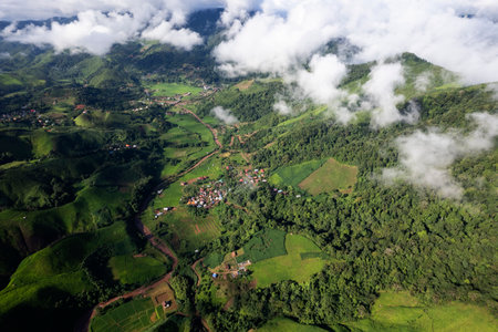 Landscape of Morning Mist with Mountain Layer. mountain ridge and clouds in rural jungle bush forestの写真素材
