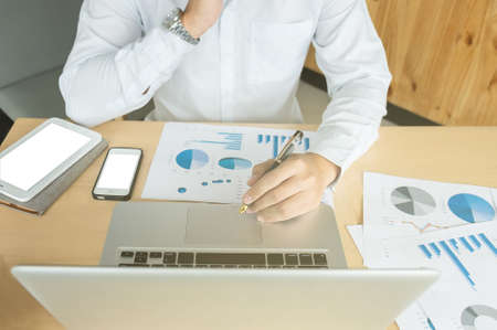 Business man working at office with laptop,tablet and documents on his desk.の写真素材