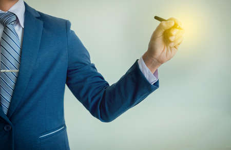 Businessman writing, drawing on the blank screen with copy space.の写真素材