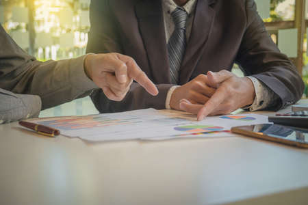 Two businessmen looking at report and having a discussion in office. business concept.の写真素材