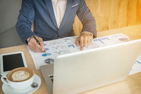 businessman working plan the business and analysis many chart graph.