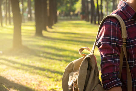Young Man Traveler with backpack relaxing outdoor on background Summer vacations and Lifestyle hiking concept.の写真素材