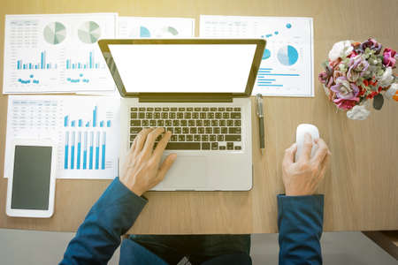 Businessman working at office desk and using a digital tablet, computer, laptop and many documen new project plan of business.の写真素材