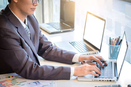 business man working document and laptop in office morning light. business concept.の写真素材