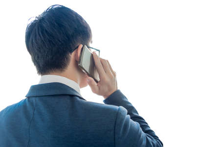 businessman talking on a mobile phone and working on isolated white background, business concept.の写真素材