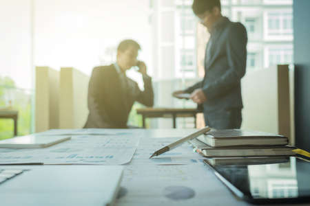 young coworkers crew working with new startup project in modern loft. Pen, laptop, analyze plans on desk.の写真素材