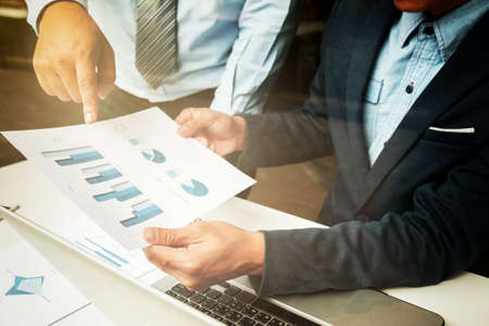Teamwork process, Businessmen hands pointing at tablet and document during explanation of new plan project data at meeting.の写真素材