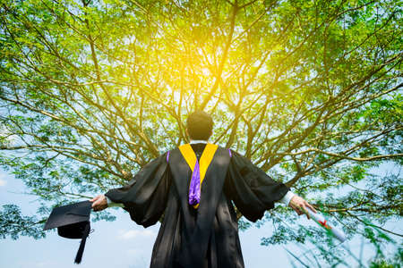 successful graduating student with nature background.の写真素材
