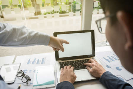 Image of business partners discussing documents and ideas at meeting.の写真素材