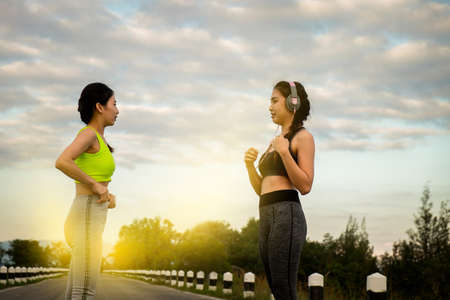 Young fitness woman practicing yoga on the field, healthy lifestyle concept.の写真素材