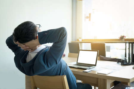 Young business man having a little rest after work in officeの写真素材