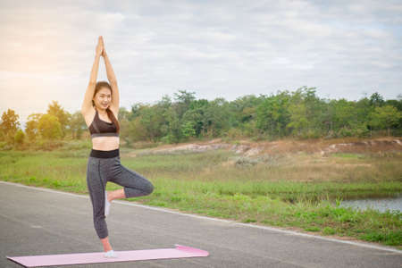Yoga in the park, health woman, Yoga woman. Concept of healthy lifestyle and relaxation. Meditation.の写真素材