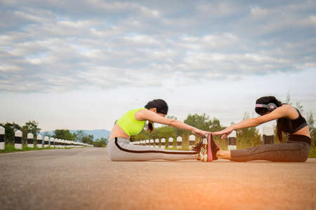 Sport and Health Lifestyle, Two Beautiful Young Woman Warm Down After Training.の写真素材