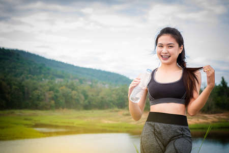 Sport and Health Lifestyle, Beautiful Young Woman Drinking Water After Training.の写真素材