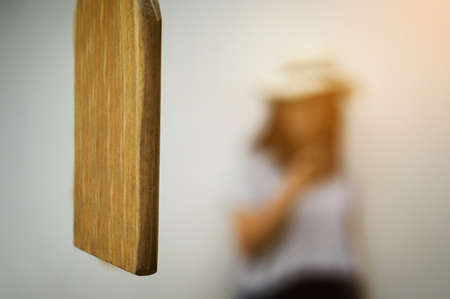 Close up of Wood Bell Lumber and blurred woman background.の写真素材