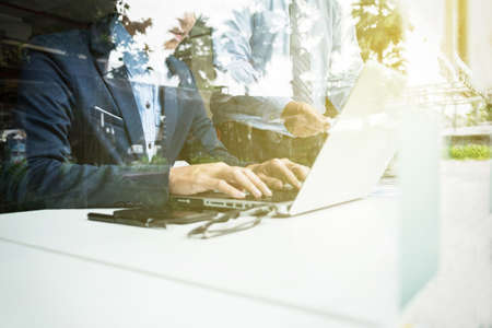 Teamwork process, Image of two young businessmen using laptop at meeting.の写真素材