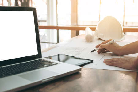 Image of engineer or architectural project, Close up of engineer's hand drawing plan on BluePrint with Engineering tools on workplace, Construction concept..の写真素材
