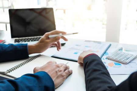 Business team meeting working with new startup project, discussion and analysis data the charts and graphs. Digital tablet calculator, laptop computer using, Business finances and accounting concept.の写真素材