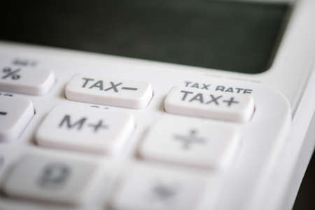 Close up of tax button on business white calculator.の写真素材