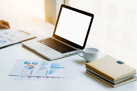 Business man working at office with laptop and documents on his desk. Analyze plans, papers, hands keyboard, business concept.の写真素材