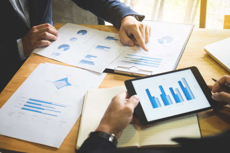 Two colleague excultive conference presentating report of new plan marketing to development consultating business in company, using digital tablet.の写真素材