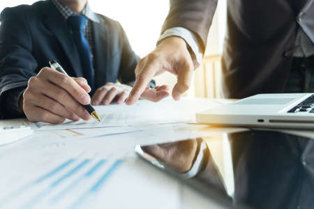 Coworking process, young business managers crew working new startup project with document graph,...