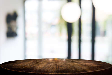 Image of Selected focus empty wooden table and Coffee shop or blurred cafe background of abstract with bokeh image. for montage or display your products.の写真素材
