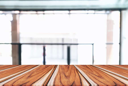 Image of Selected focus empty wooden table and Coffee shop or blurred cafe background of abstract...