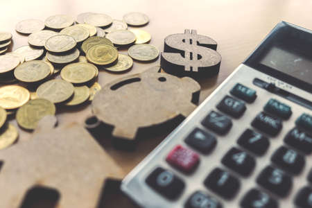 Business background with money, calculator, piggy and house model.の写真素材