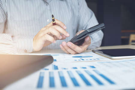 Business man or accountant working Financial investment on calculator with calculate Analyze business and market growth on financial document data graph and tablet, Accounting, Economic, commercial.の写真素材