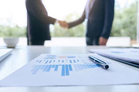 Young executive colleagues discussing and analysis working with new startup project Financial investment on tablet Analyze business and market growth on financial document data graph, handshake.の写真素材