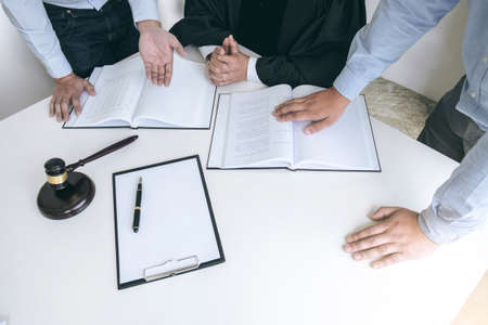 Close up of gavel, Male lawyer and older judge Consult with client on the case and working with Law...