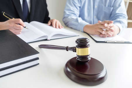 Close up of gavel, Male lawyer or judge Consult with client and working with Law books, report the...