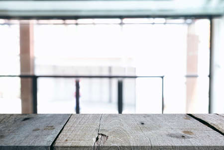 Image of Selected focus empty wooden table and Coffee shop or blurred cafe background of abstract with bokeh image. for montage or display your products.の写真素材