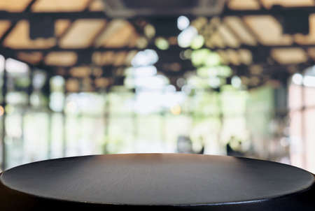 Image of Selected focus empty wooden table and Coffee shop or blurred cafe background of abstract with bokeh image. for montage or display your products.の写真素材