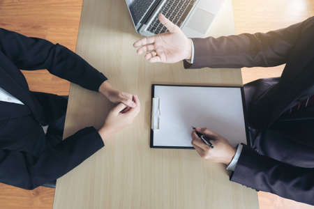 Job interview, Young attractive executives man asking questions to applicant about work history, colloquy dream,  Skill, expertise, experience and businessman listen to candidate answers.の写真素材