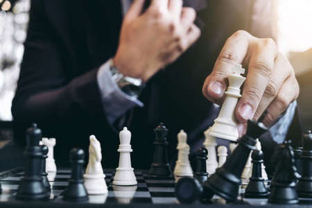 Close up of hands confident businessman colleagues playing chess game to development analysis new...